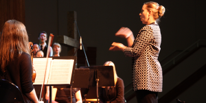 Artistic Director Erika McCauley conducts choirs and orchestra at Songs of Hope Concert in Salem, Oregon.